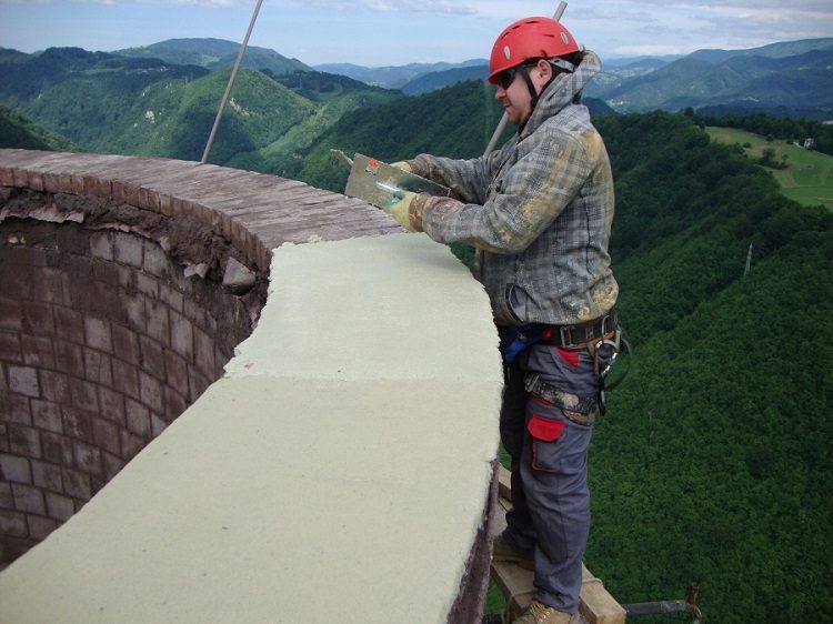 Les tuyaux en brique et en béton armé des chaufferies industrielles sont parfois restaurés à l'aide d'une couche de plâtre Réparation de cheminée